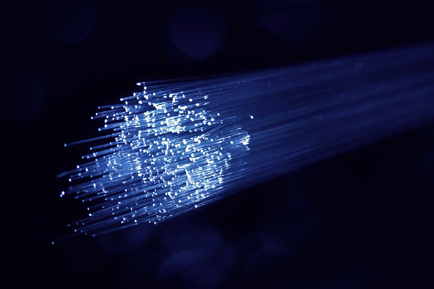Glowing blue fiber optic cables transmitting data.